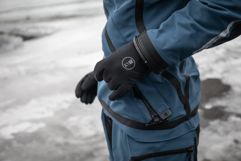 scuba diver zipping up their fourth element trilaminate drysuit